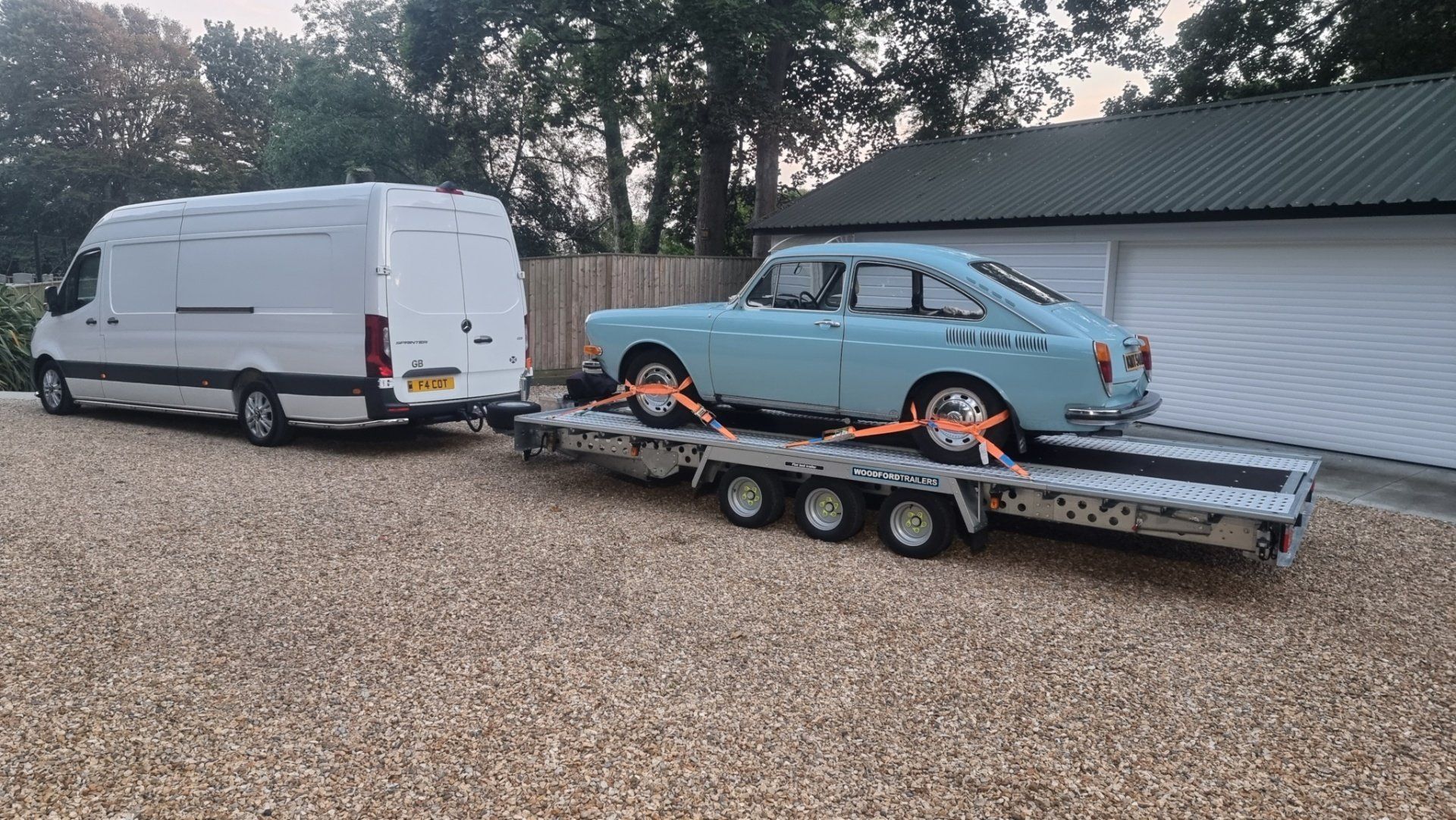A light blue classic car on a trailer towed by a Mercedes Sprinter, ready for transport  by MTC Transport