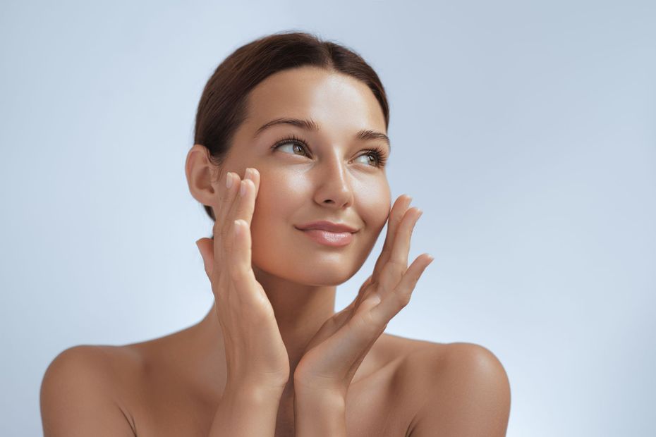 Close up of woman touching her face
