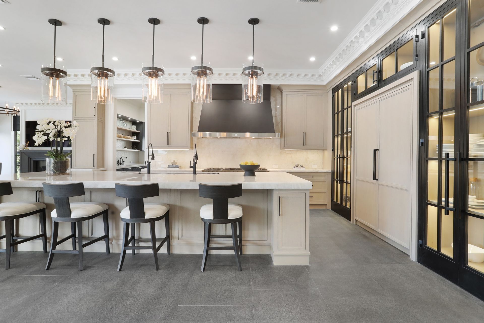 A kitchen with a large island and stools.
