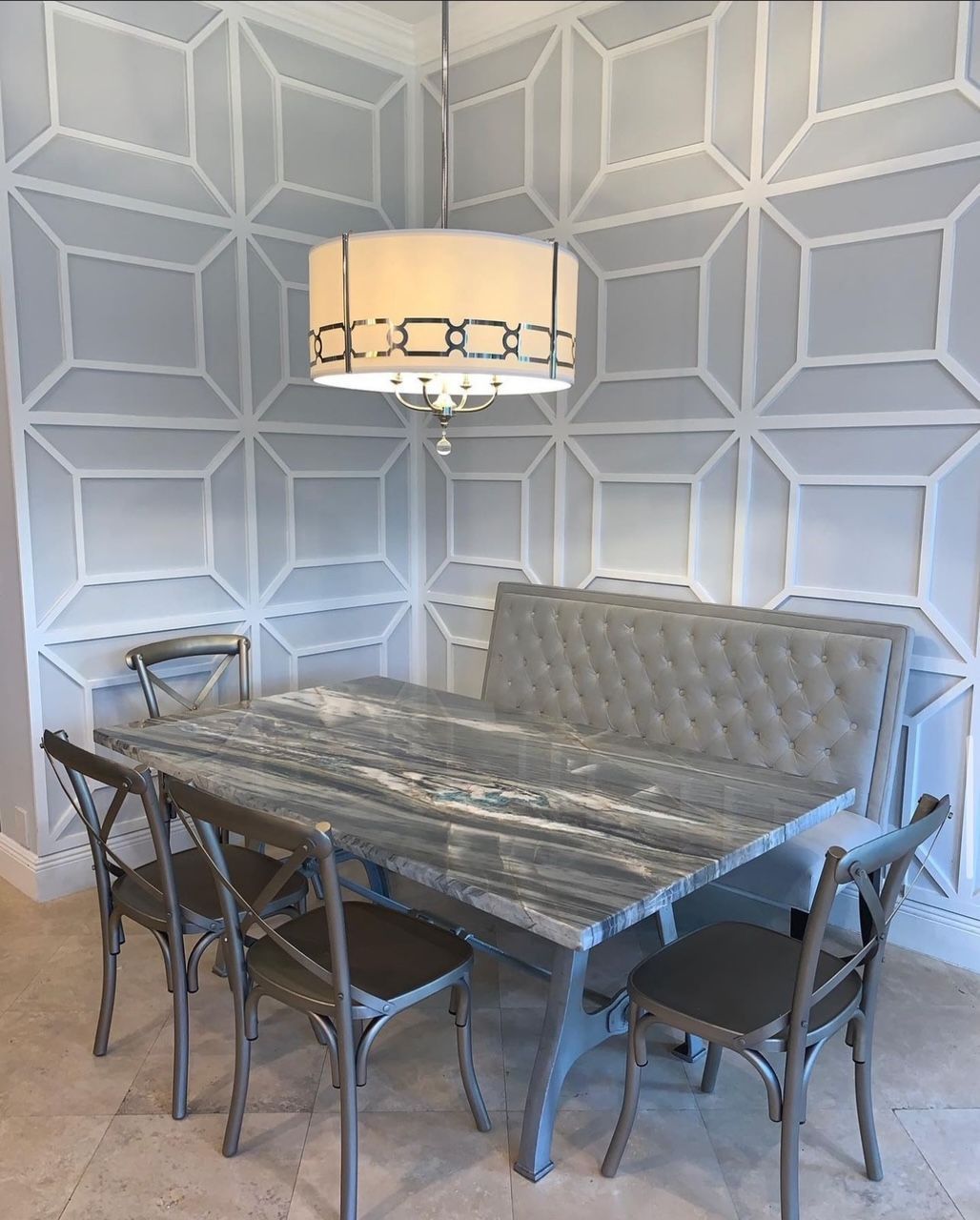 A dining room with a table and chairs and a chandelier.