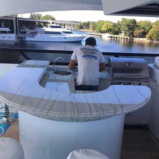 A man is working in a kitchen on a boat.