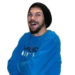 a man with a beard is wearing a blue sweater and a black beanie .