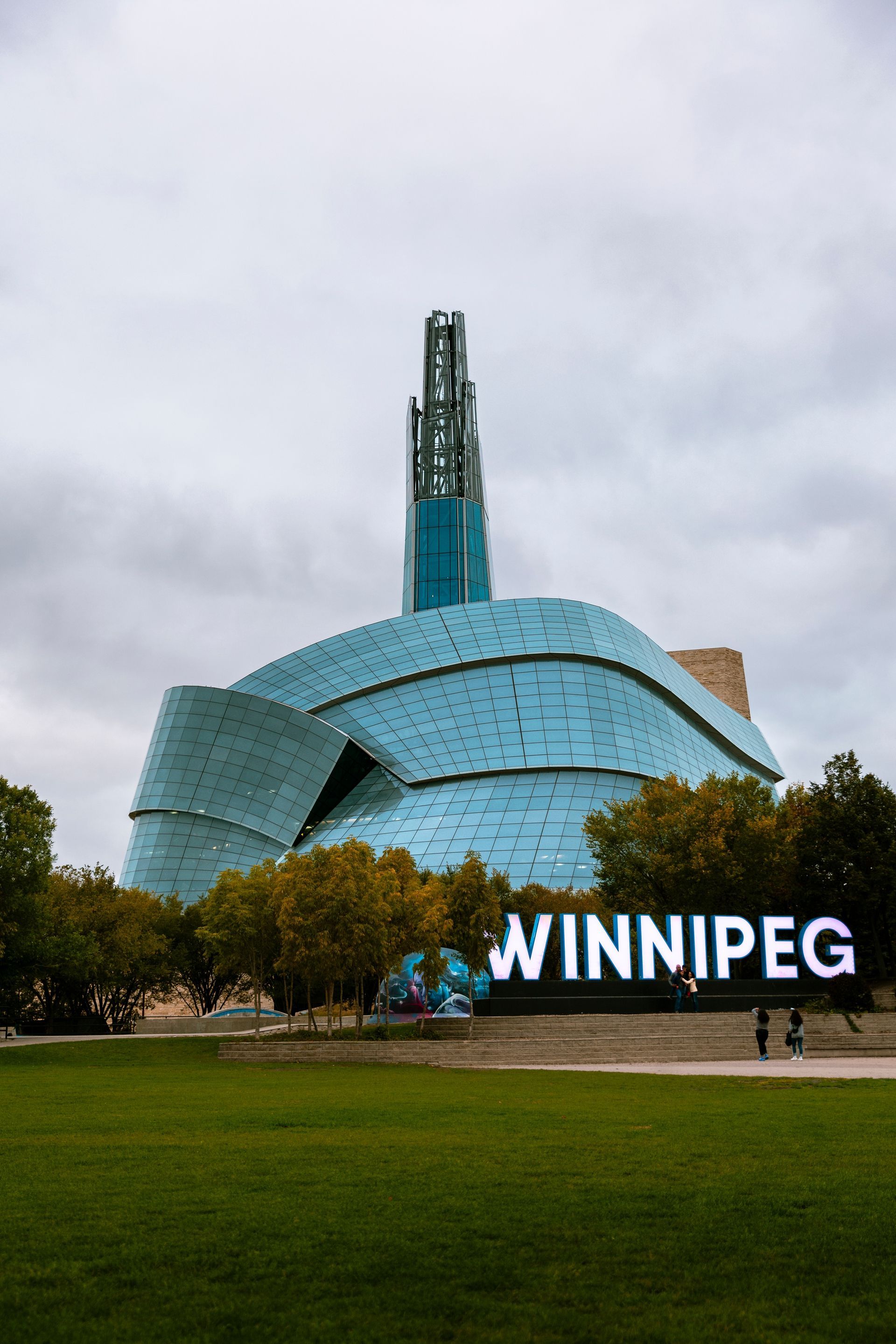 A large building with a sign that says winnipeg in front of it.