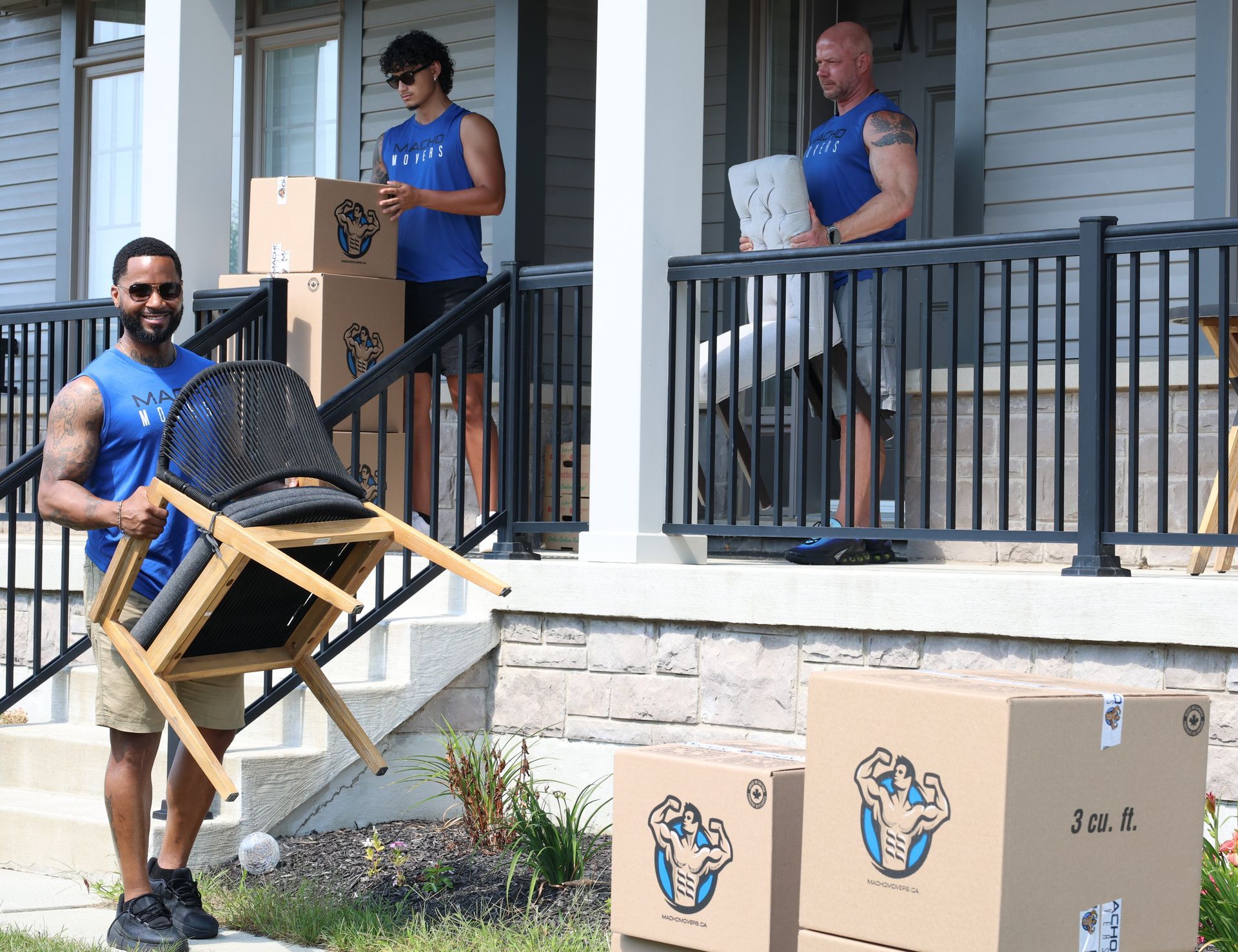 a group of movers are loading boxes into a van .