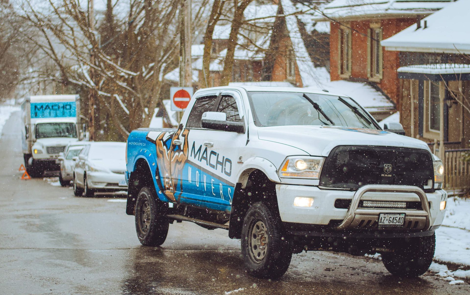 a white truck is parked on the side of the road in the snow .