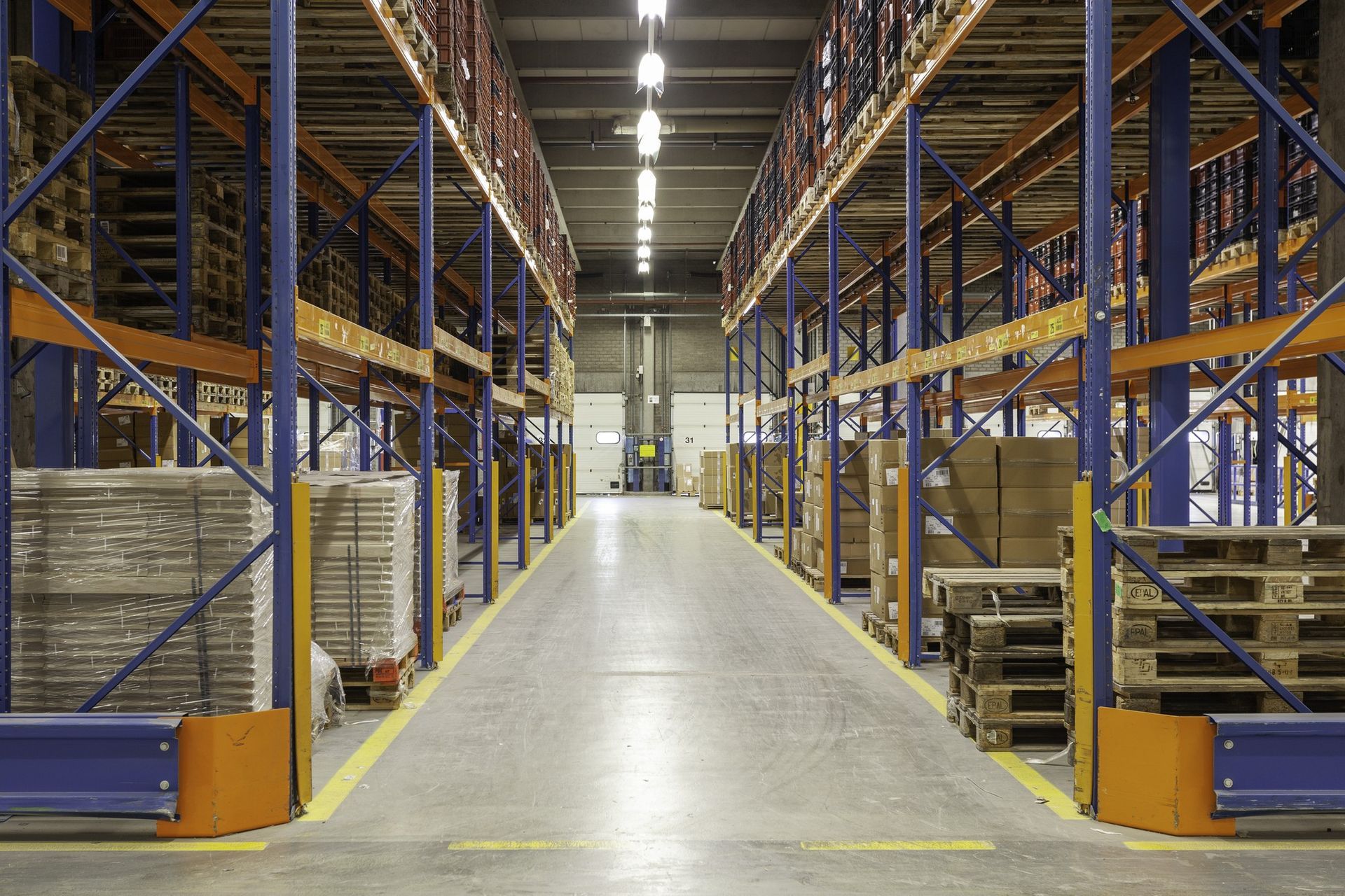 A large warehouse filled with lots of shelves and pallets.