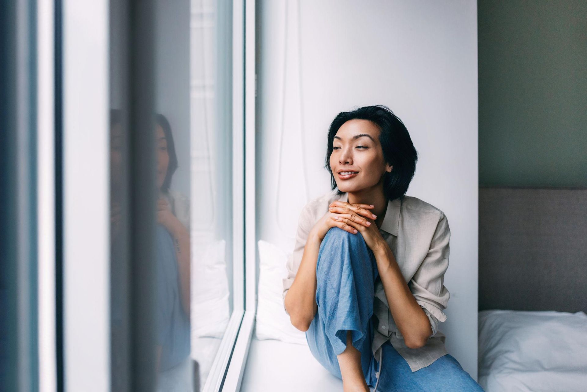 Person Relaxing by a Window in a Calm and Reflective Mood