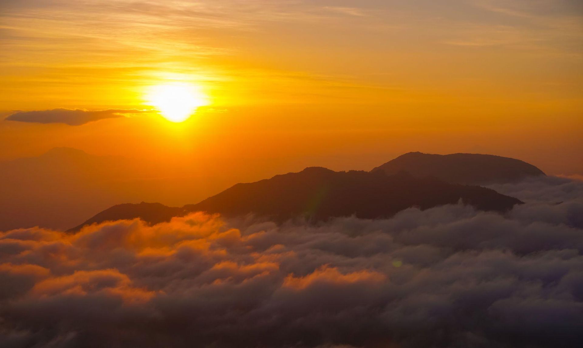 Golden sunrise mountain peak with a sea of clouds