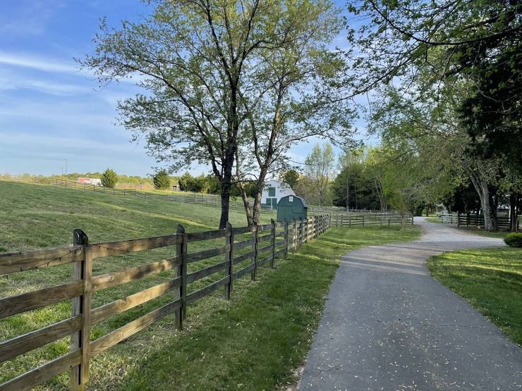 There is a wooden fence along the side of the road.