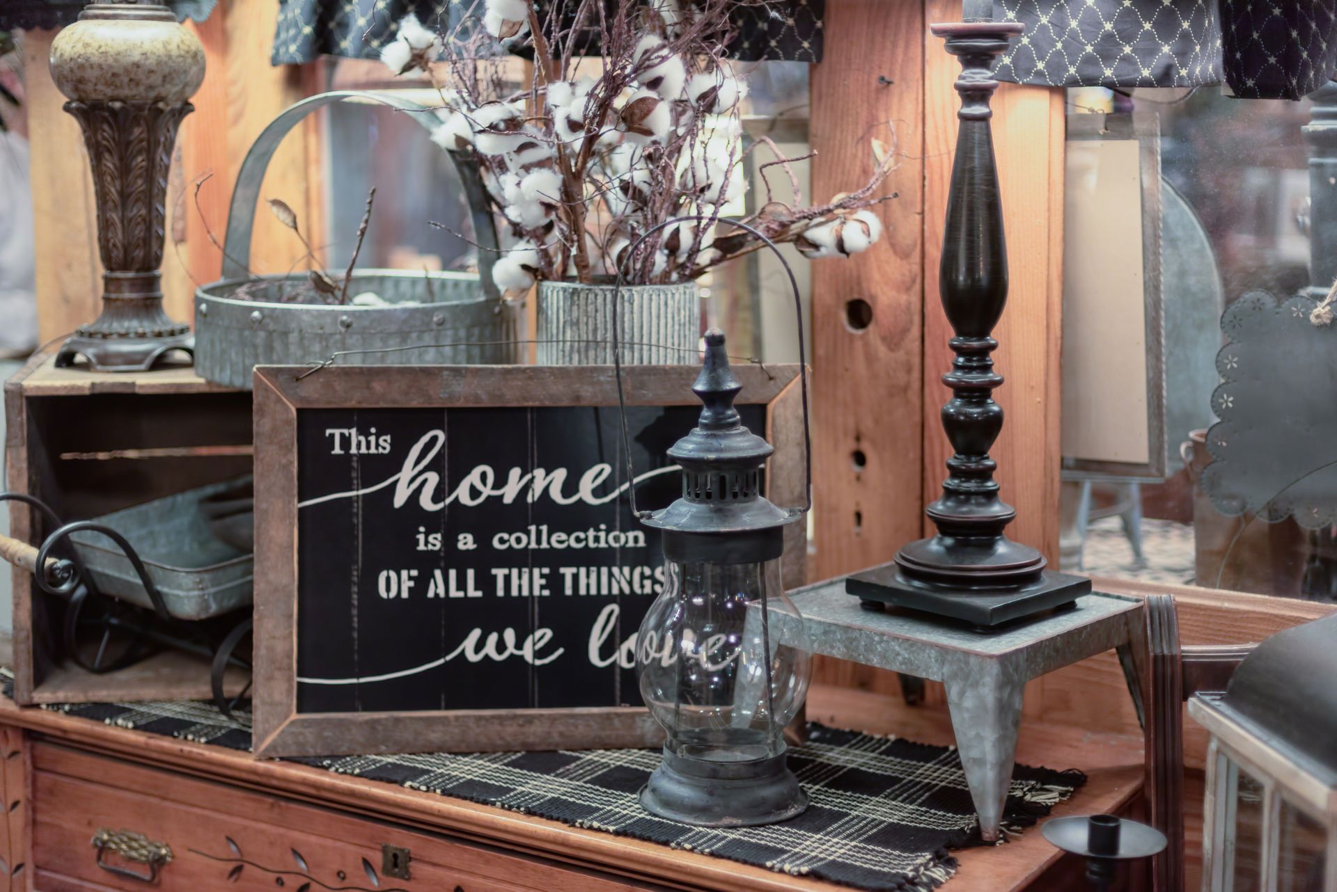 A sign that says `` this home is a collection of all the things we love '' is on a table.