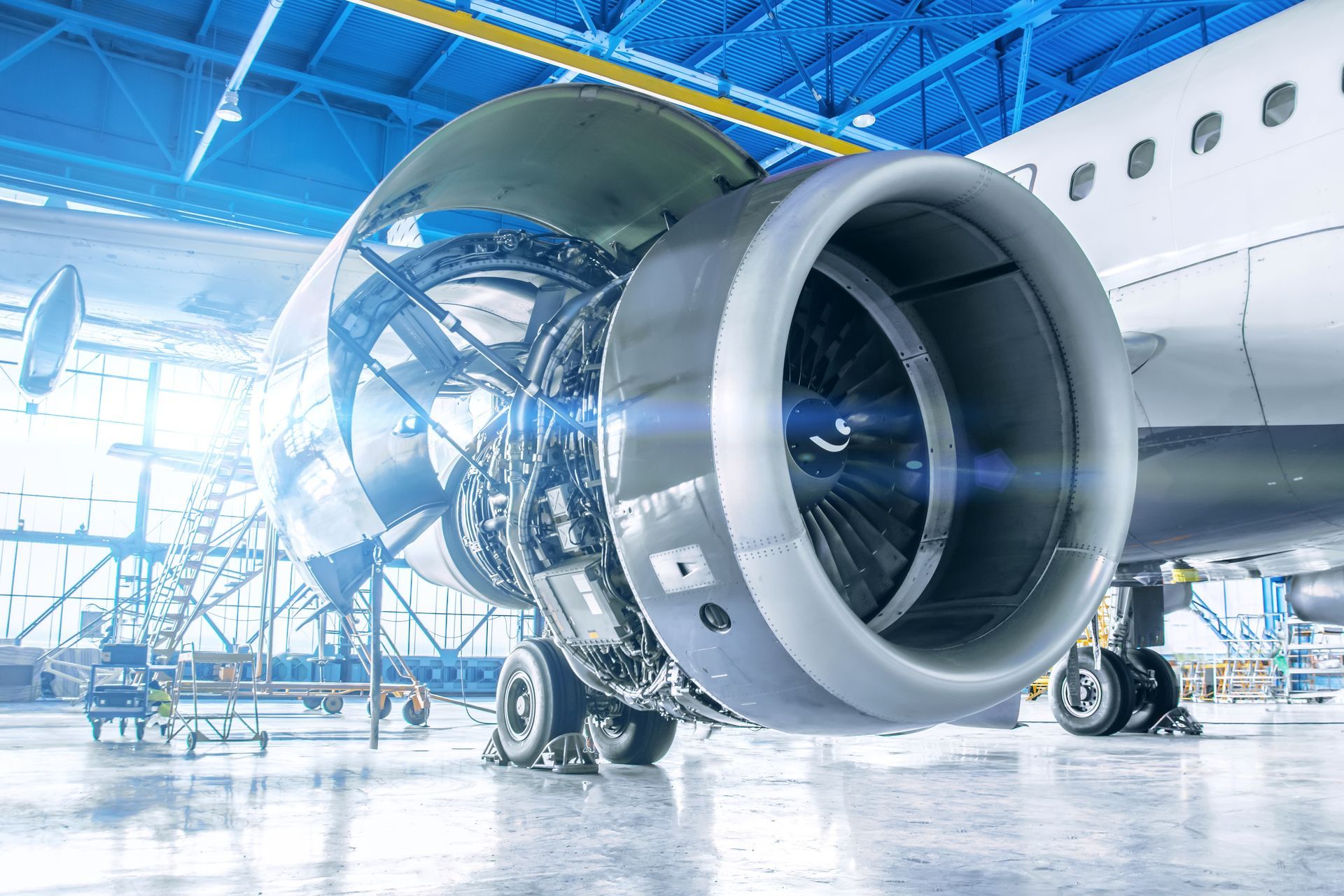 An airplane engine is being repaired in a hangar.