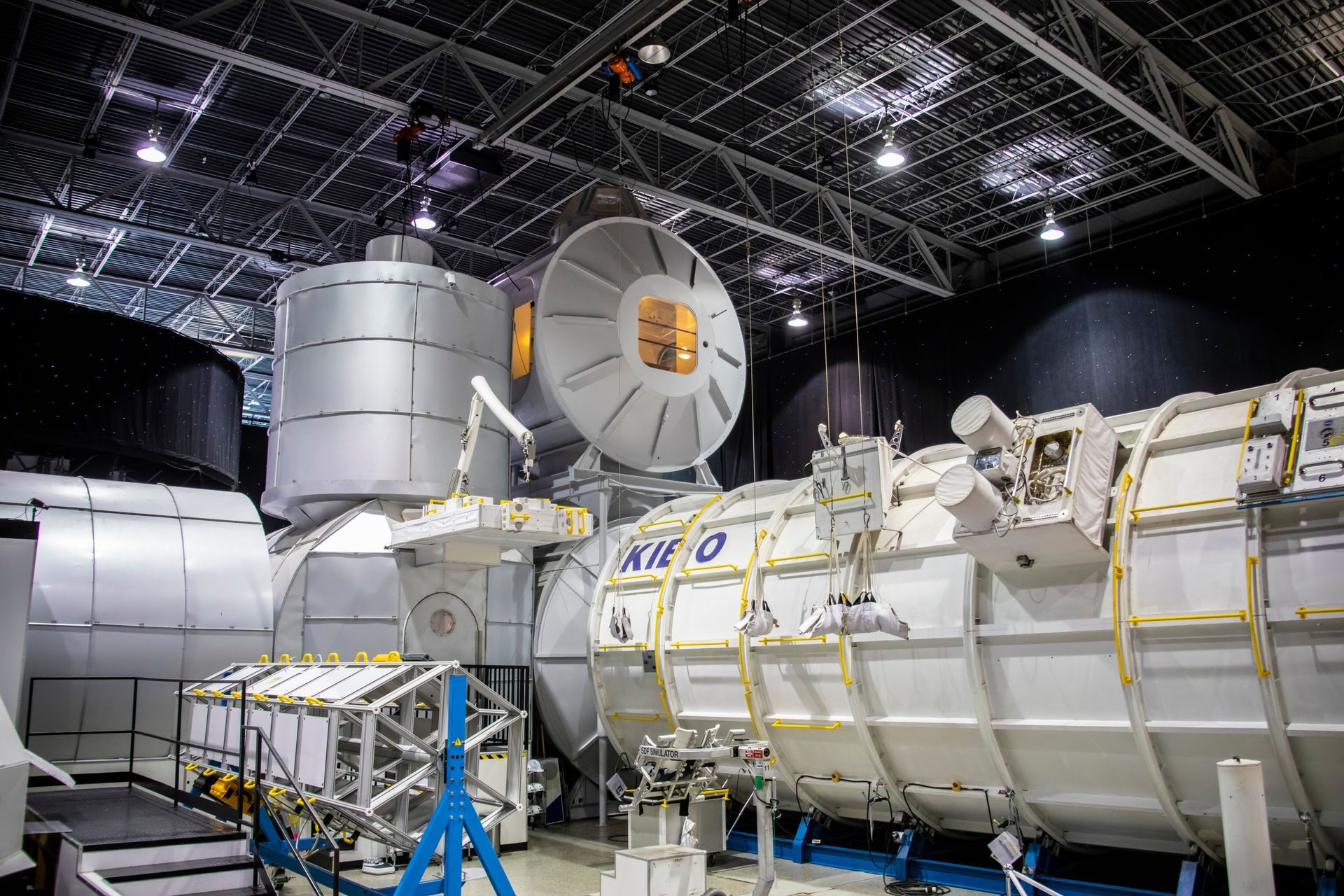 A model of a space station is being built in a hangar.