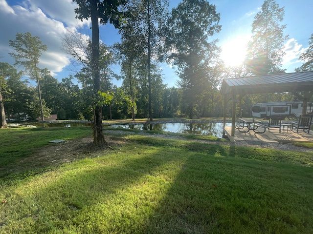 View of a pond at the Red Coach Resort with sunlight 
