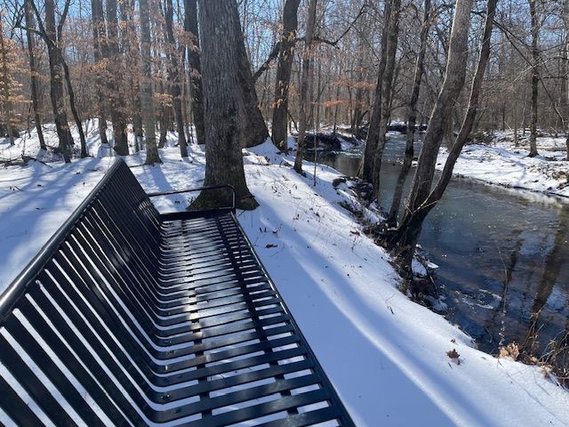Snow covered bench beside the waterway walk at the Red Coach Resort 
