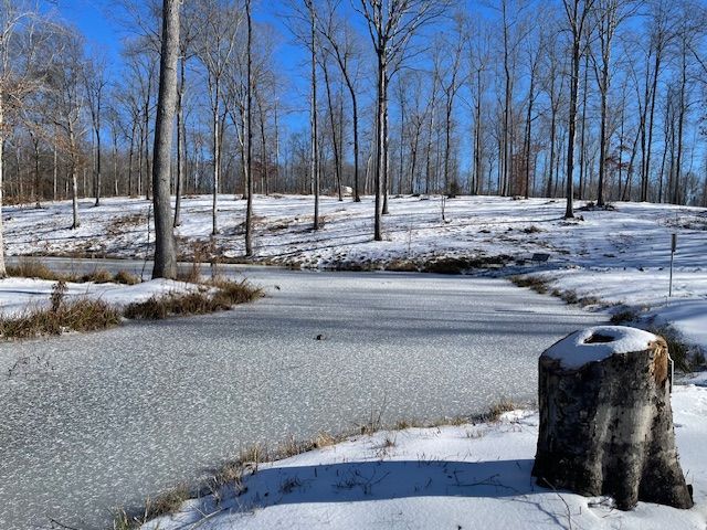 Snowfall and frozen pond at Red Coach Resort Camp F
