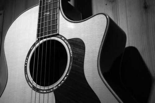 A black and white photo of an acoustic guitar