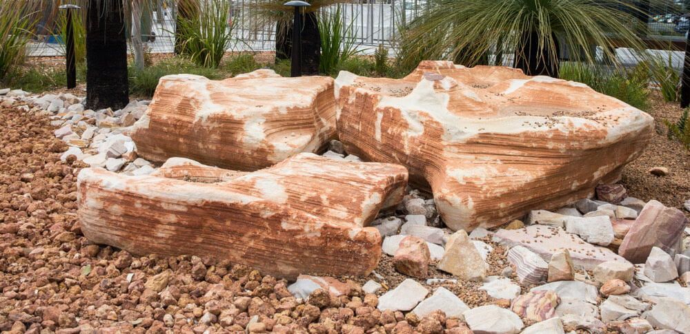 Three Large, Layered Sandstone Rocks in a Landscaped Bed — Coastal Sand Soil & Mulch in Maryborough, QLD
