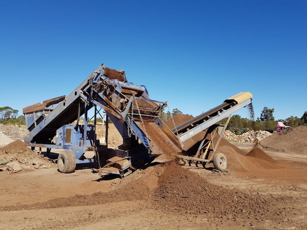 Blue Soil Screening Machine Sorting Piles of Dirt Outdoors — Coastal Sand Soil & Mulch in Craignish, QLD