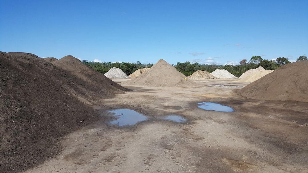 Piles of Sand and Soil in a Construction Yard — Coastal Sand Soil & Mulch in River Heads, QLD