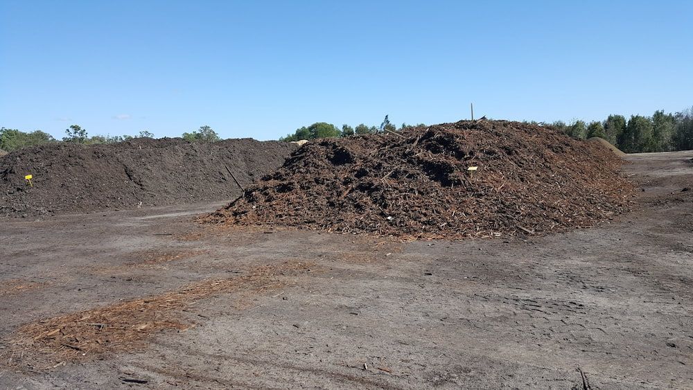 Piles of Dark Brown Mulch in an Open — Coastal Sand Soil & Mulch in River Heads, QLD