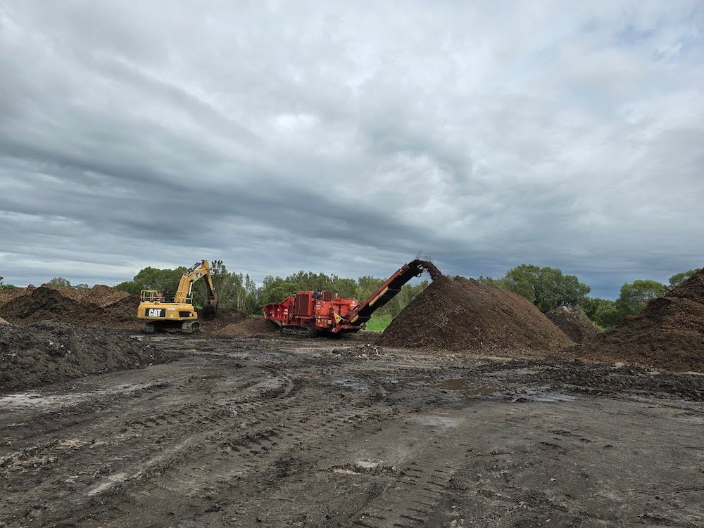 Excavator and Wood Grinder — Coastal Sand Soil & Mulch in Craignish, QLD