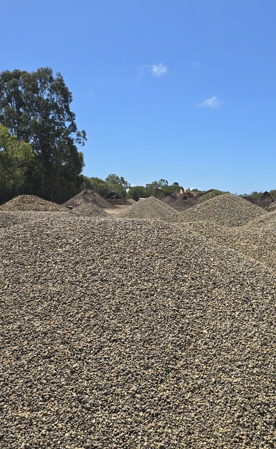 Pile of gravel under a bright blue sky — Coastal Sand Soil & Mulch in Craignish, QLD