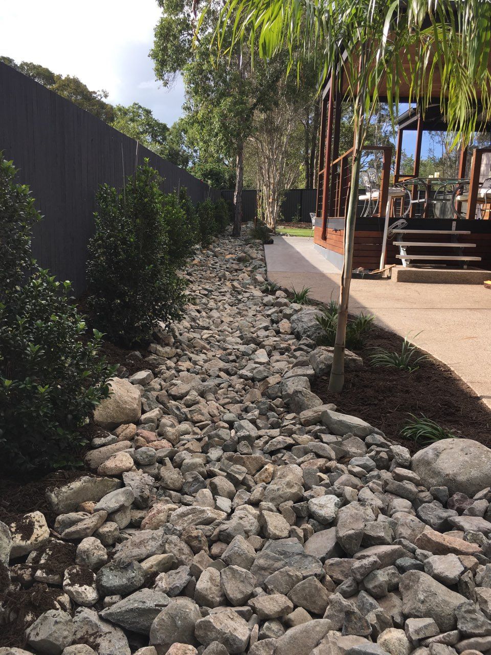 Stone Wall Composed of Irregular, Gray and Tan Rocks — Coastal Sand Soil & Mulch in Craignish, QLD
