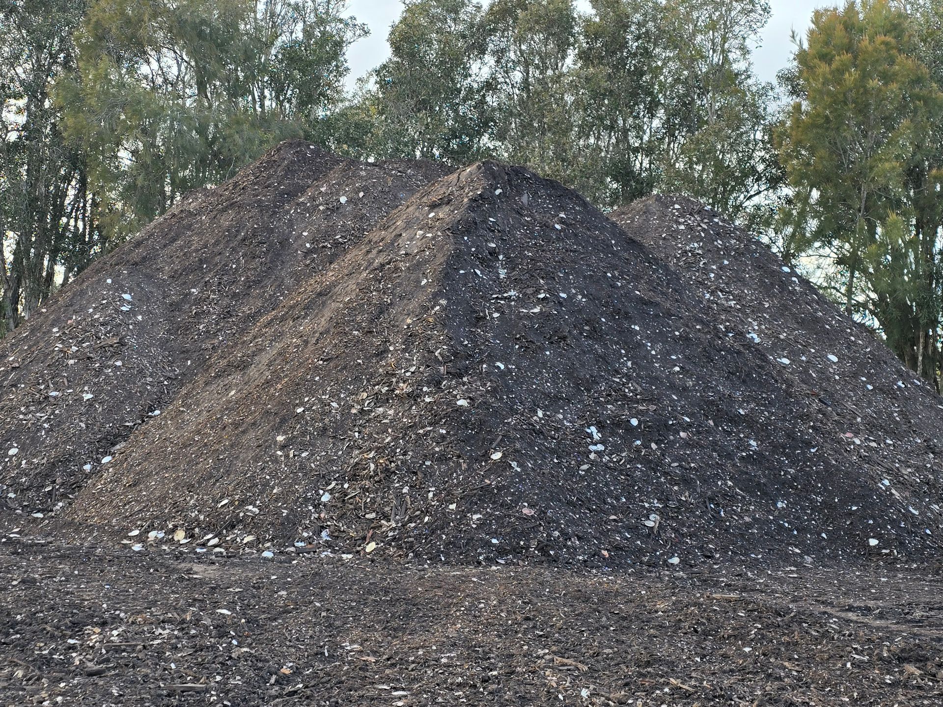 Piles of Brown Material, Possibly Soil or Mulch — Coastal Sand Soil & Mulch in Craignish, QLD