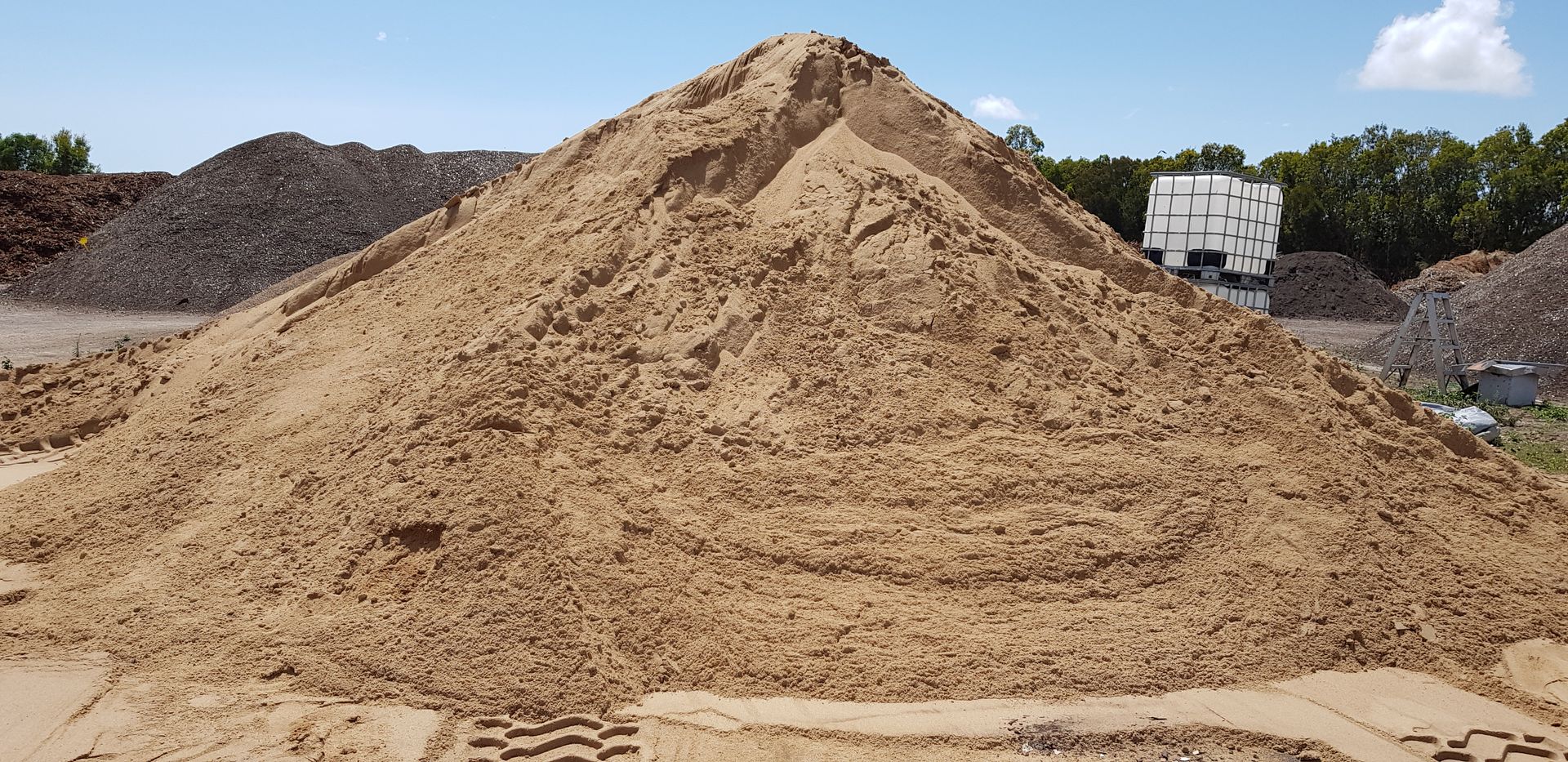 Pile of Tan Sand in A Metal Container — Coastal Sand Soil & Mulch in Craignish, QLD