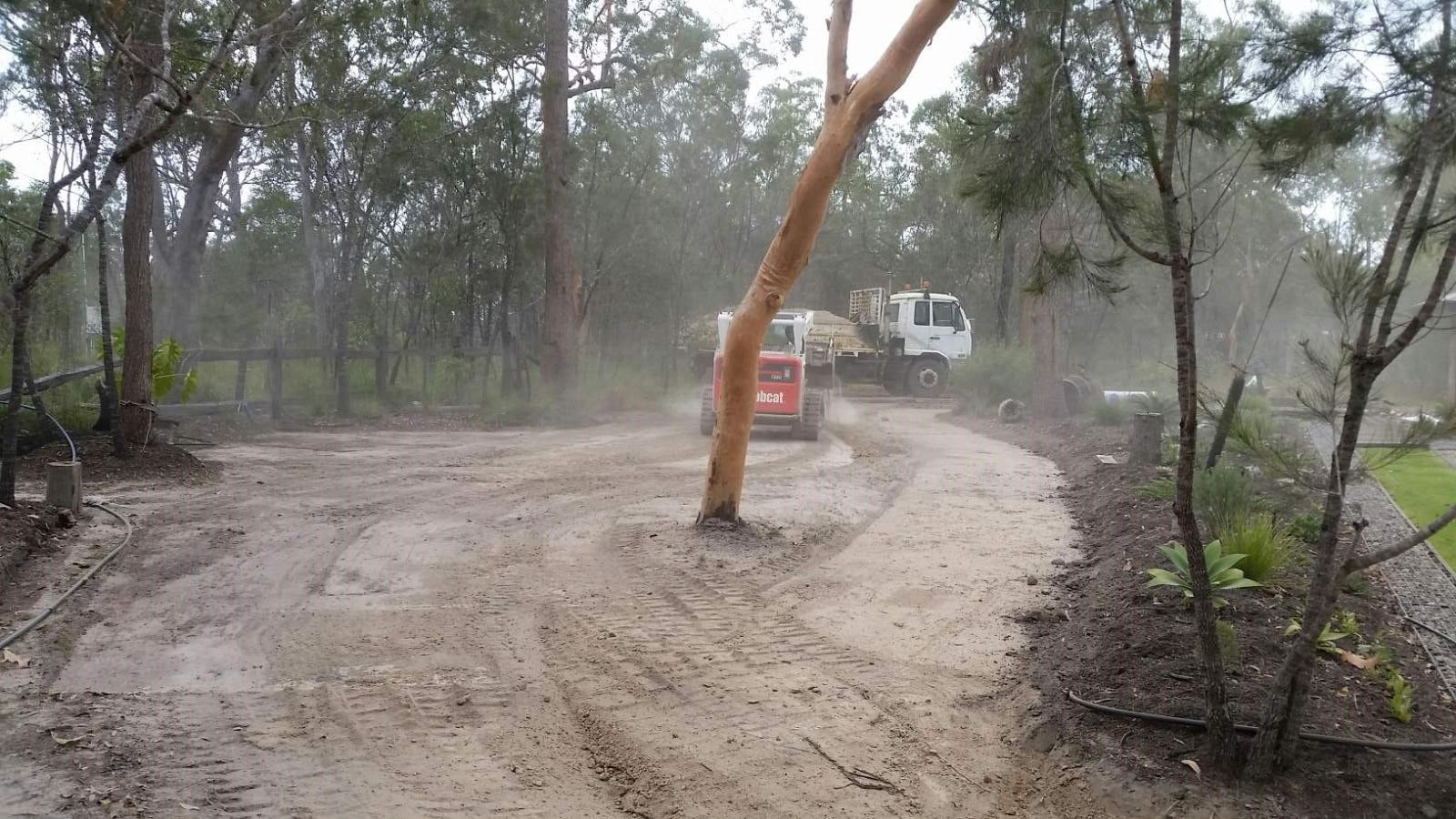 Yellow Excavator Digging in a Pile of Rocks — Coastal Sand Soil & Mulch in River Heads, QLD