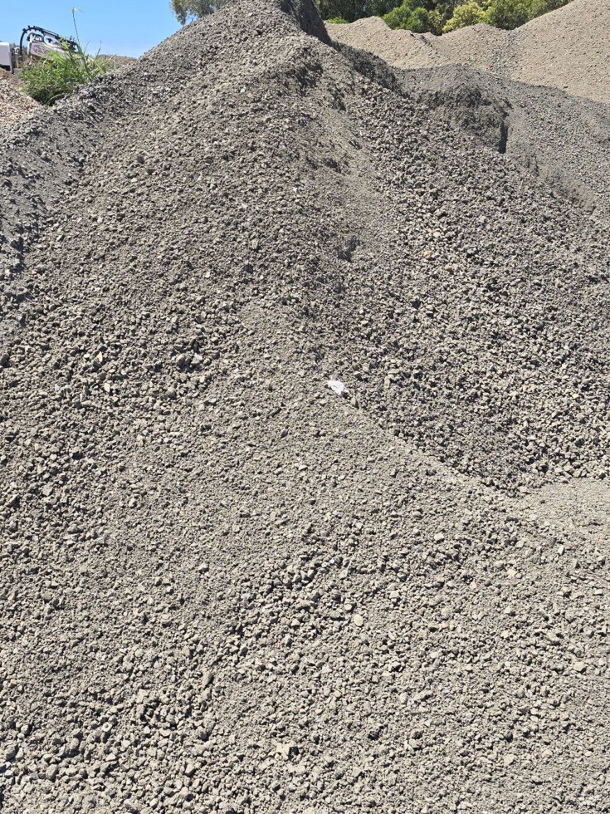 Gravel Pouring Off a Conveyor Belt — Coastal Sand Soil & Mulch in Maryborough, QLD