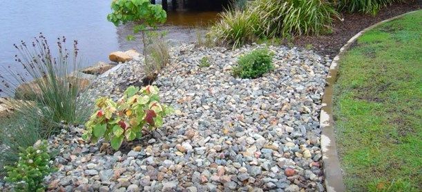 Gravel Piles on a Sandy Surface, with Concrete Blocks — Coastal Sand Soil & Mulch in Urangan, QLD