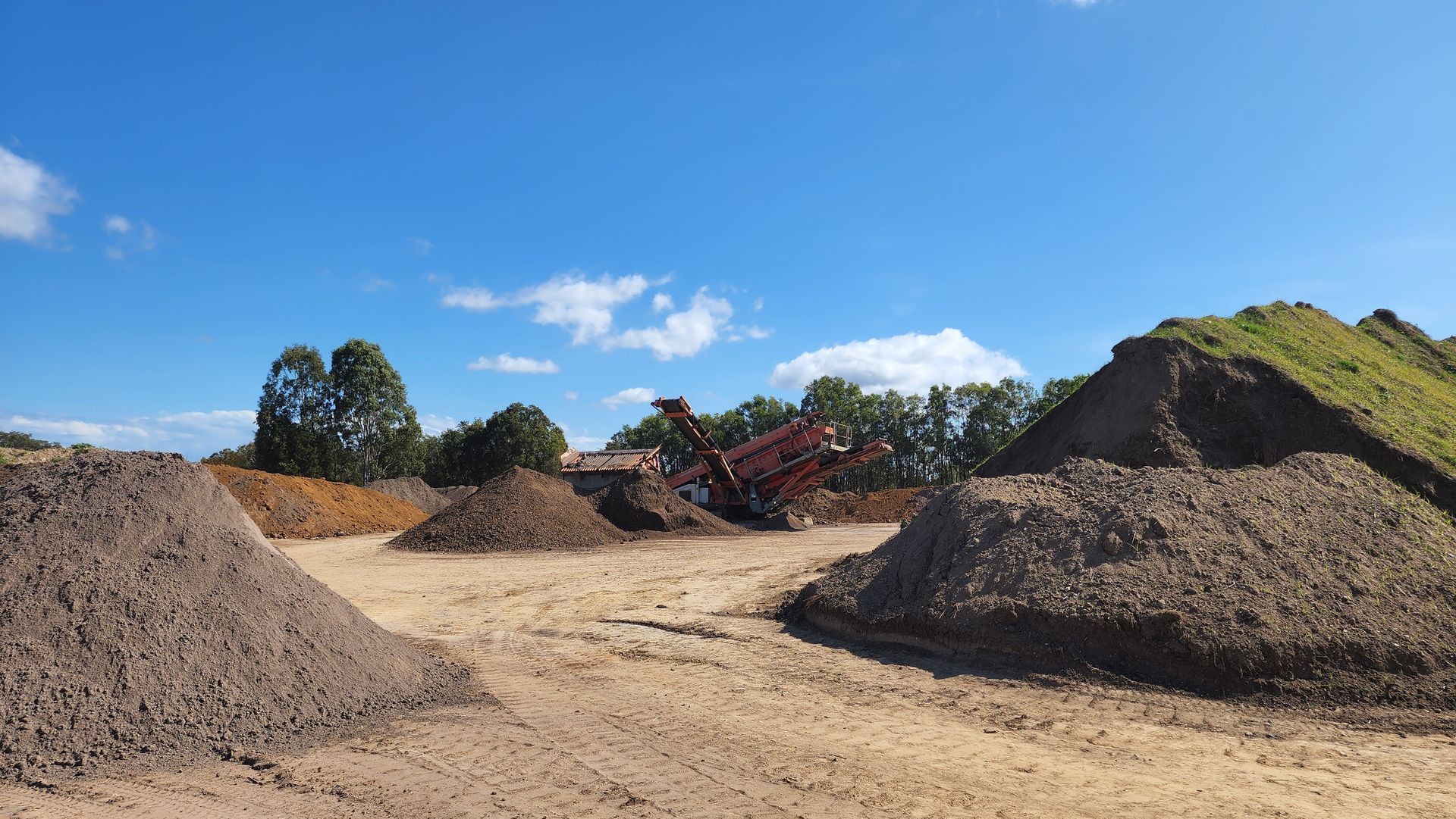 Piles Of Soil or Compost Under a Clear, Blue Sky — Coastal Sand Soil & Mulch Craignish, QLD