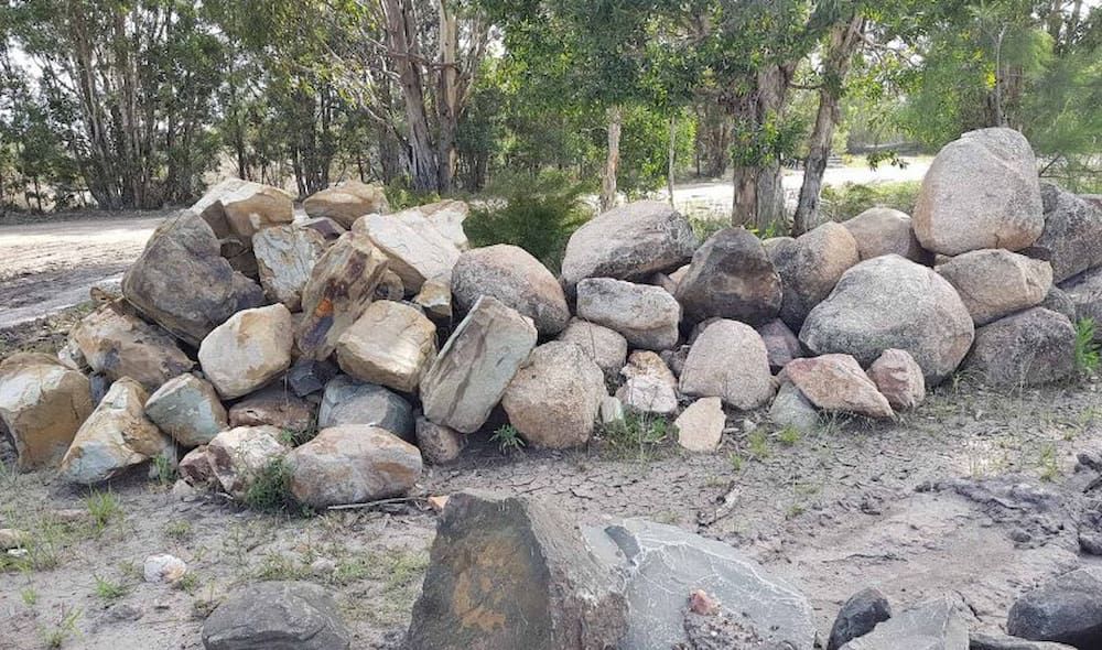 Pile of Gray and Tan Rocks in a Natural Setting — Coastal Sand Soil & Mulch in Craignish, QLD