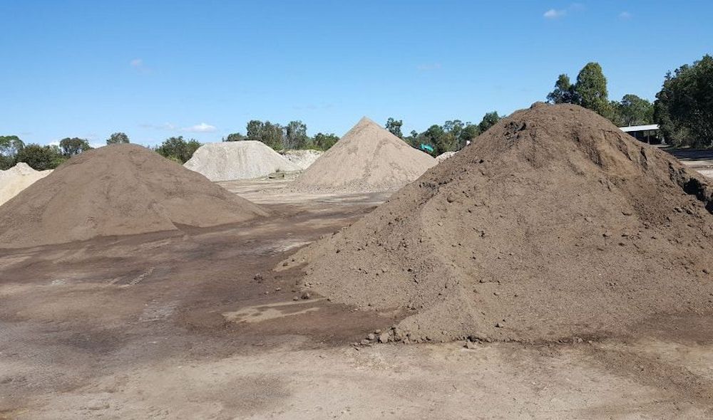 Piles of Dark Brown, Light Brown, and Tan Soil — Coastal Sand Soil & Mulch in Craignish, QLD