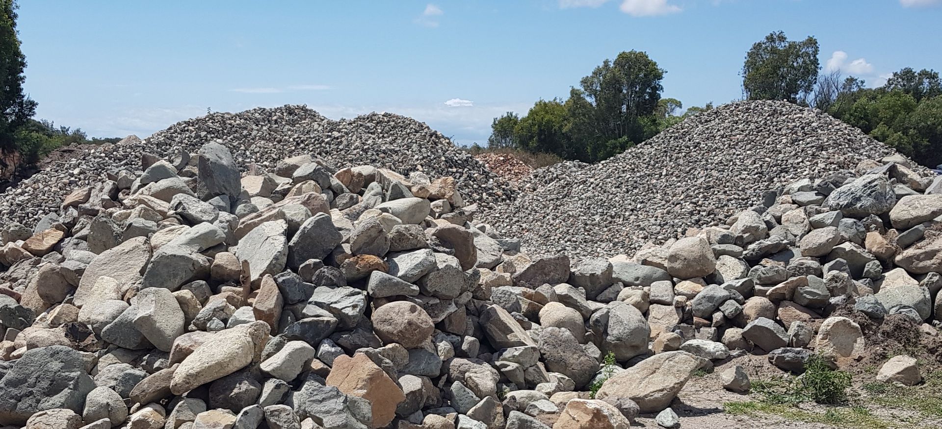 Pile of Gravel on Gray Pavement — Coastal Sand Soil & Mulch in Burrum heads, QLD
