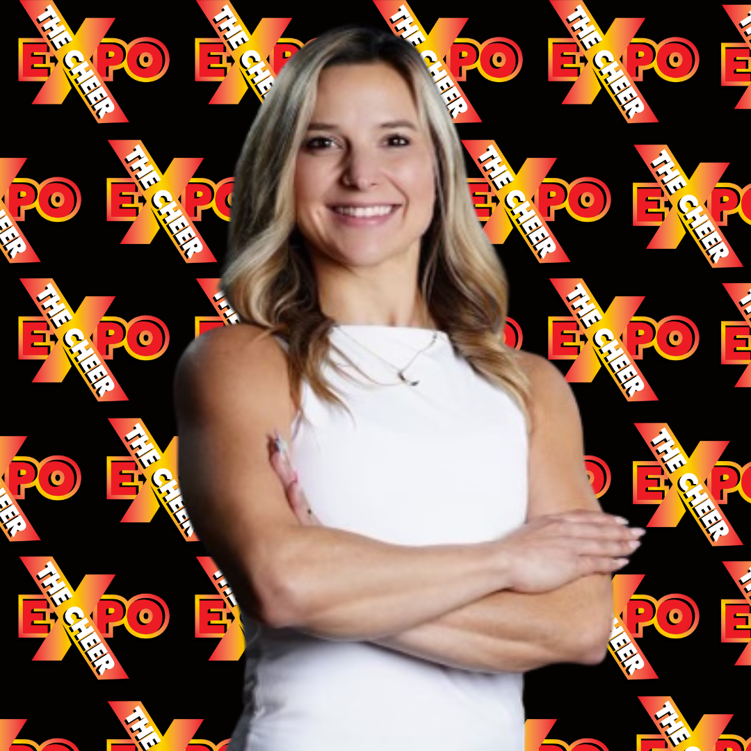 A woman is standing with her arms crossed in front of a black background with the word expo on it