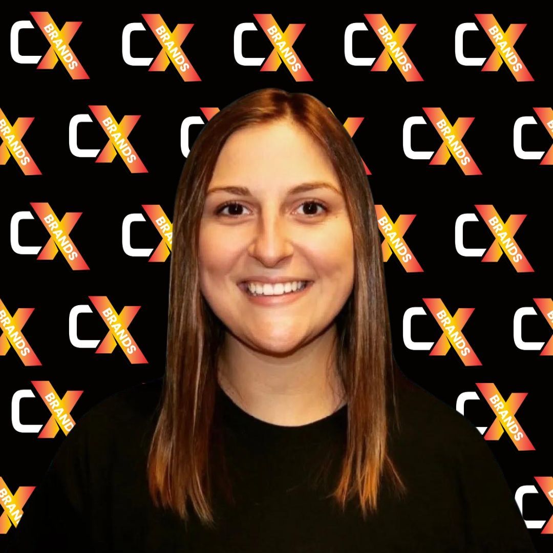 A woman is smiling in front of a black background with the word expo on it.