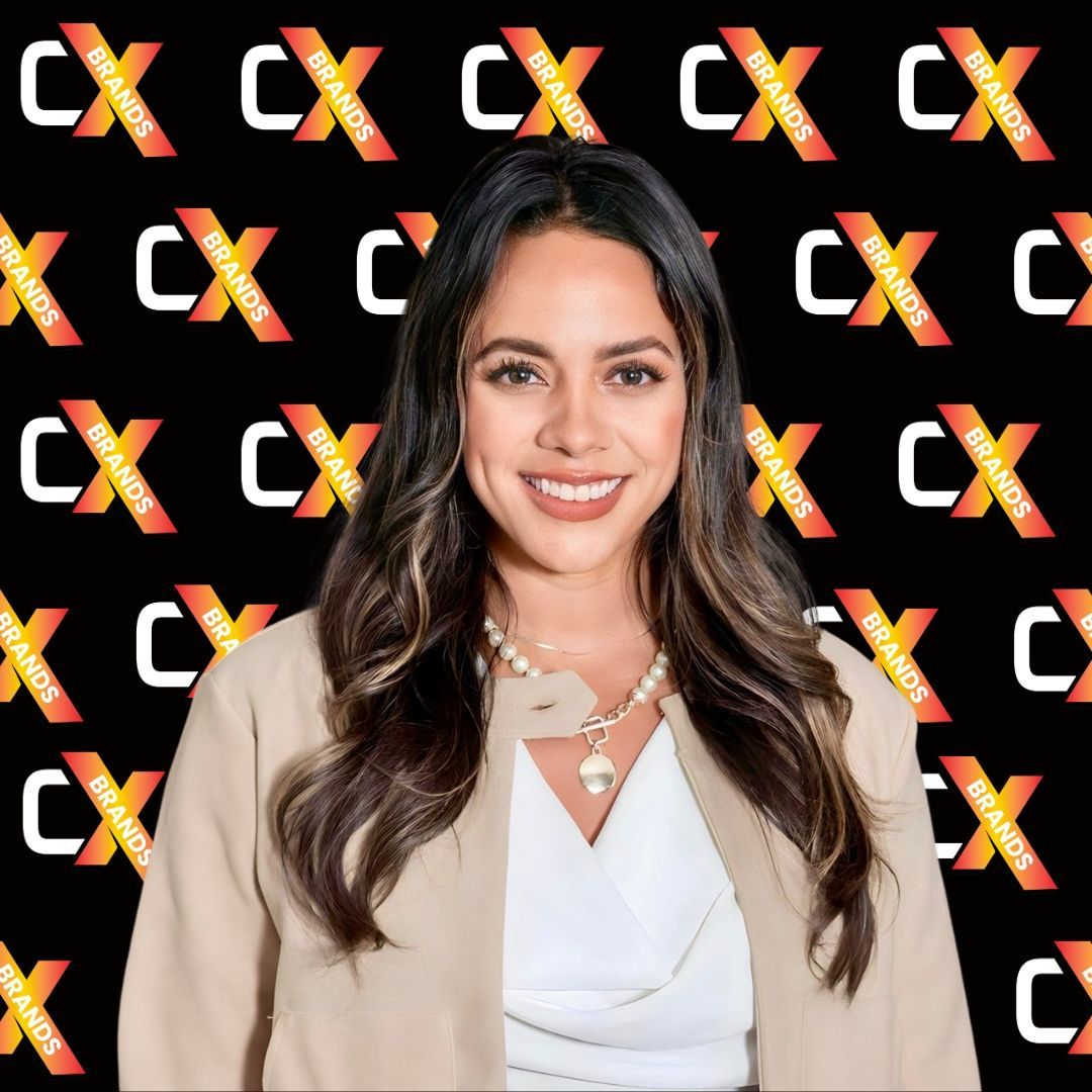 A woman is standing in front of a black background with the word expo on it.