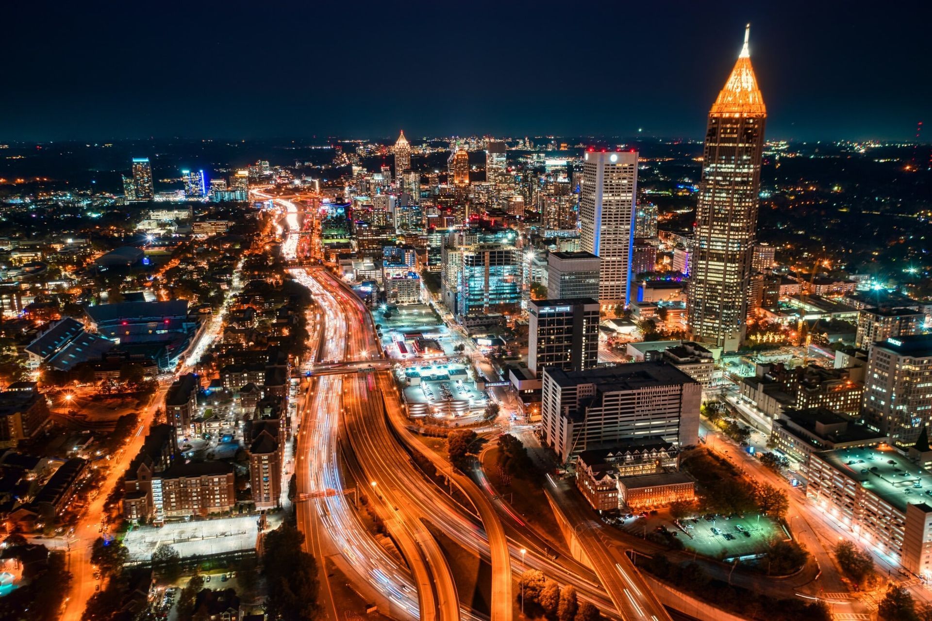 An aerial view of a city at night with lots of traffic.