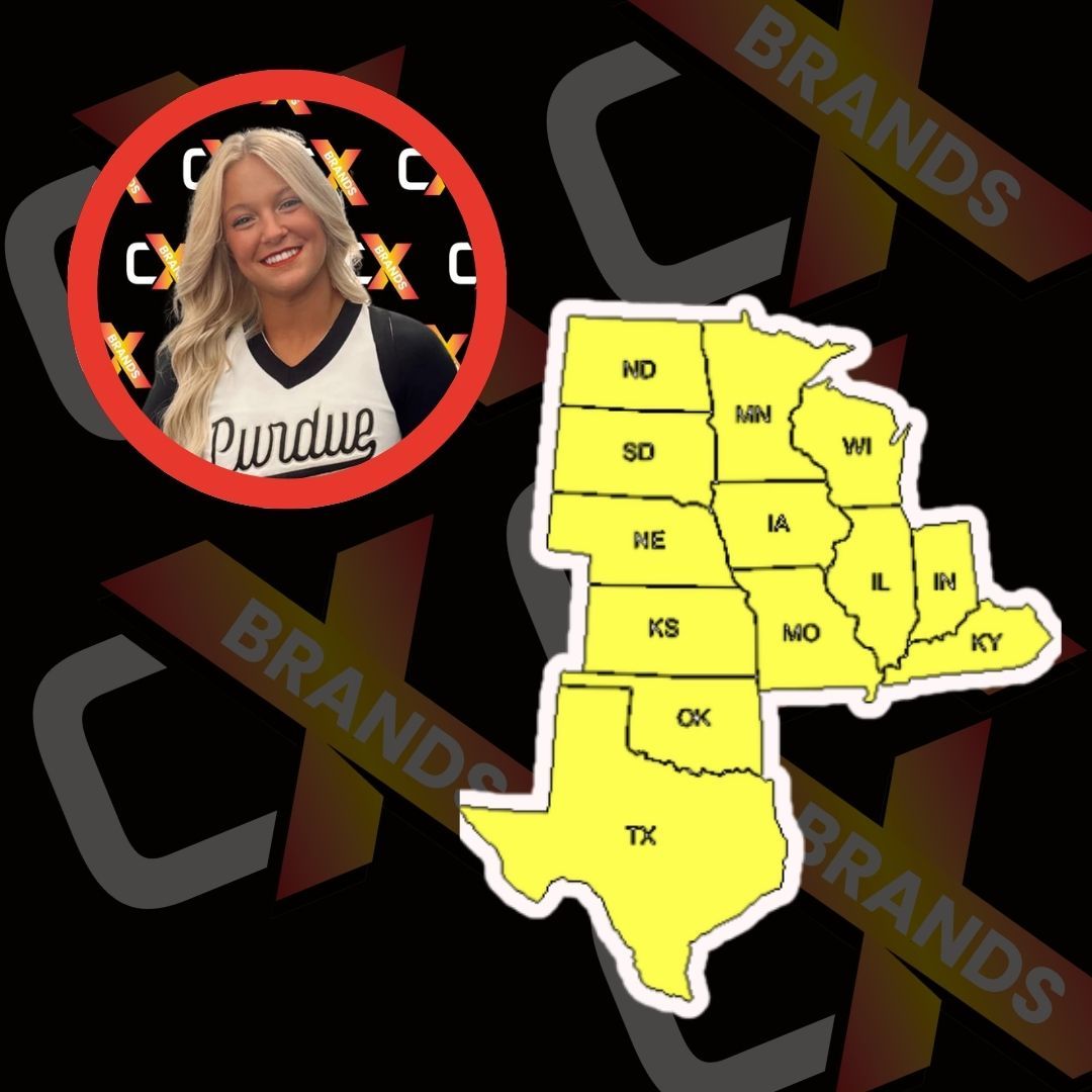 A man with a beard is smiling in front of a sign that says the expo