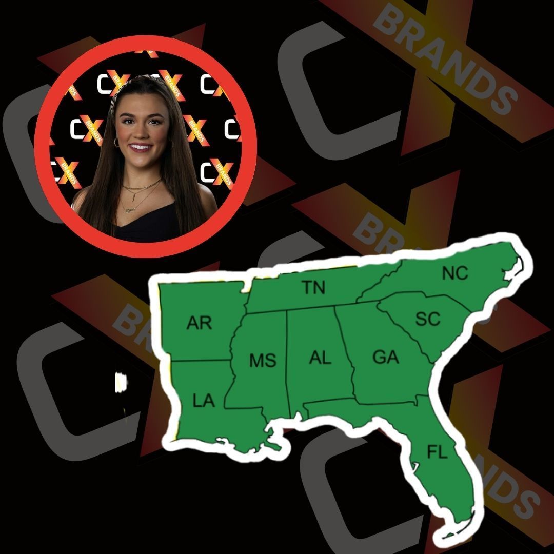 A man with a beard is smiling in front of a sign that says the expo