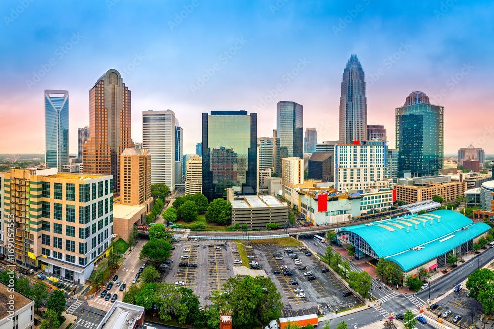 An aerial view of a city skyline with a parking lot in the foreground.