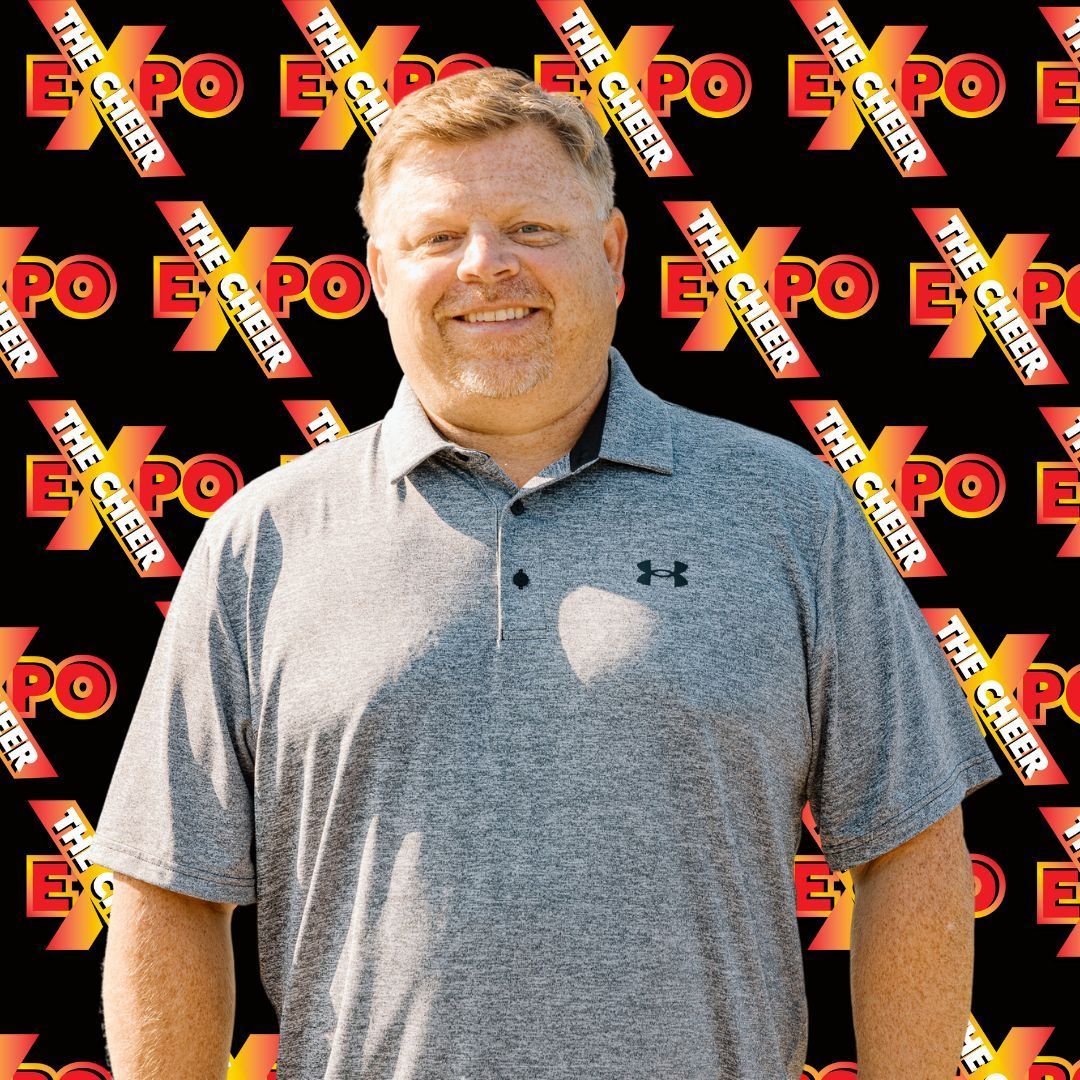 A man is standing in front of a black background with the word expo on it.