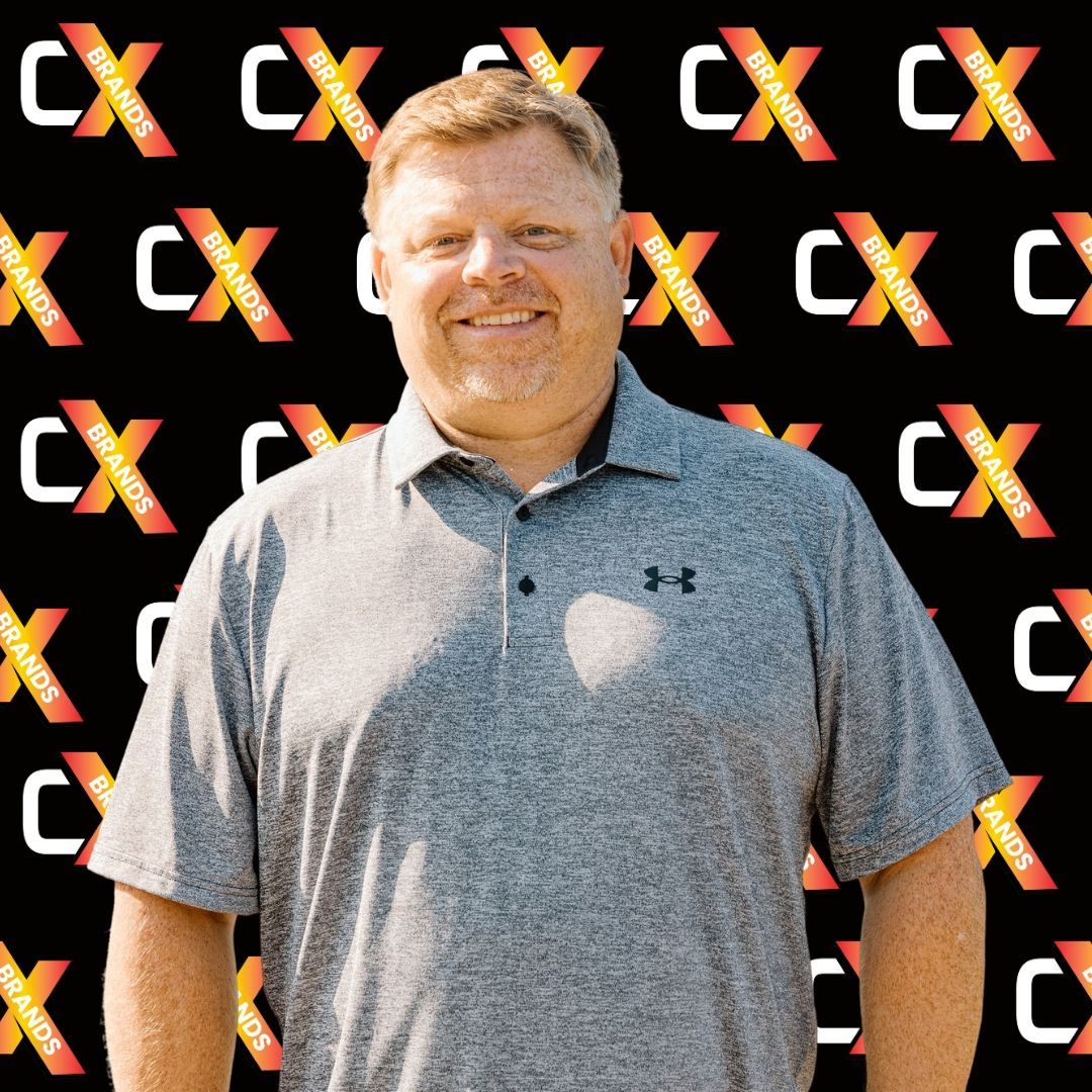 A man is standing in front of a black background with the word expo on it.