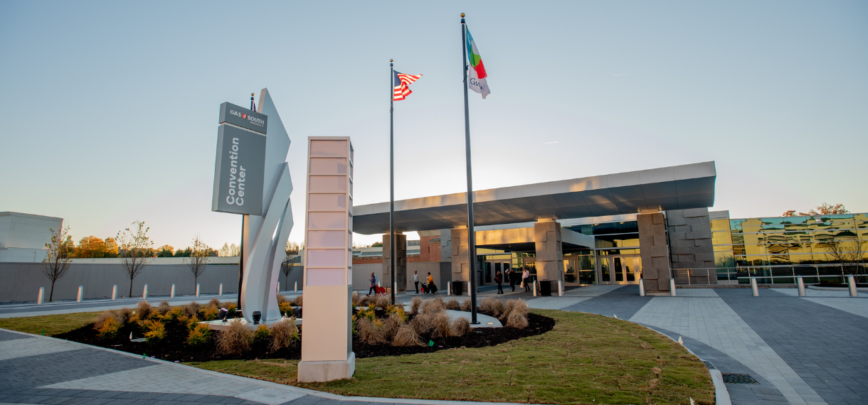 A large building with three flags flying in front of it.