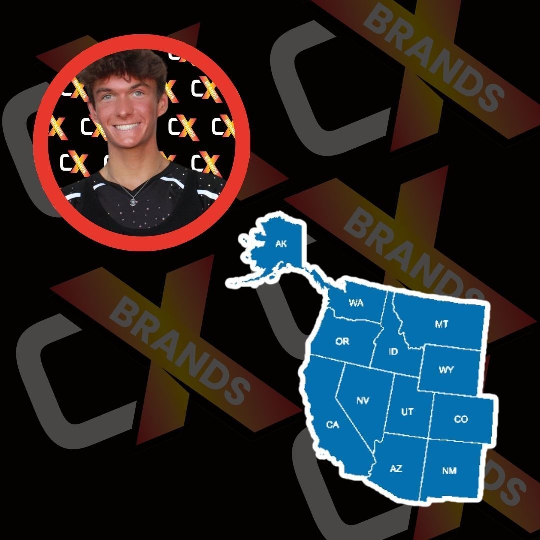 A man with a beard is smiling in front of a sign that says the expo