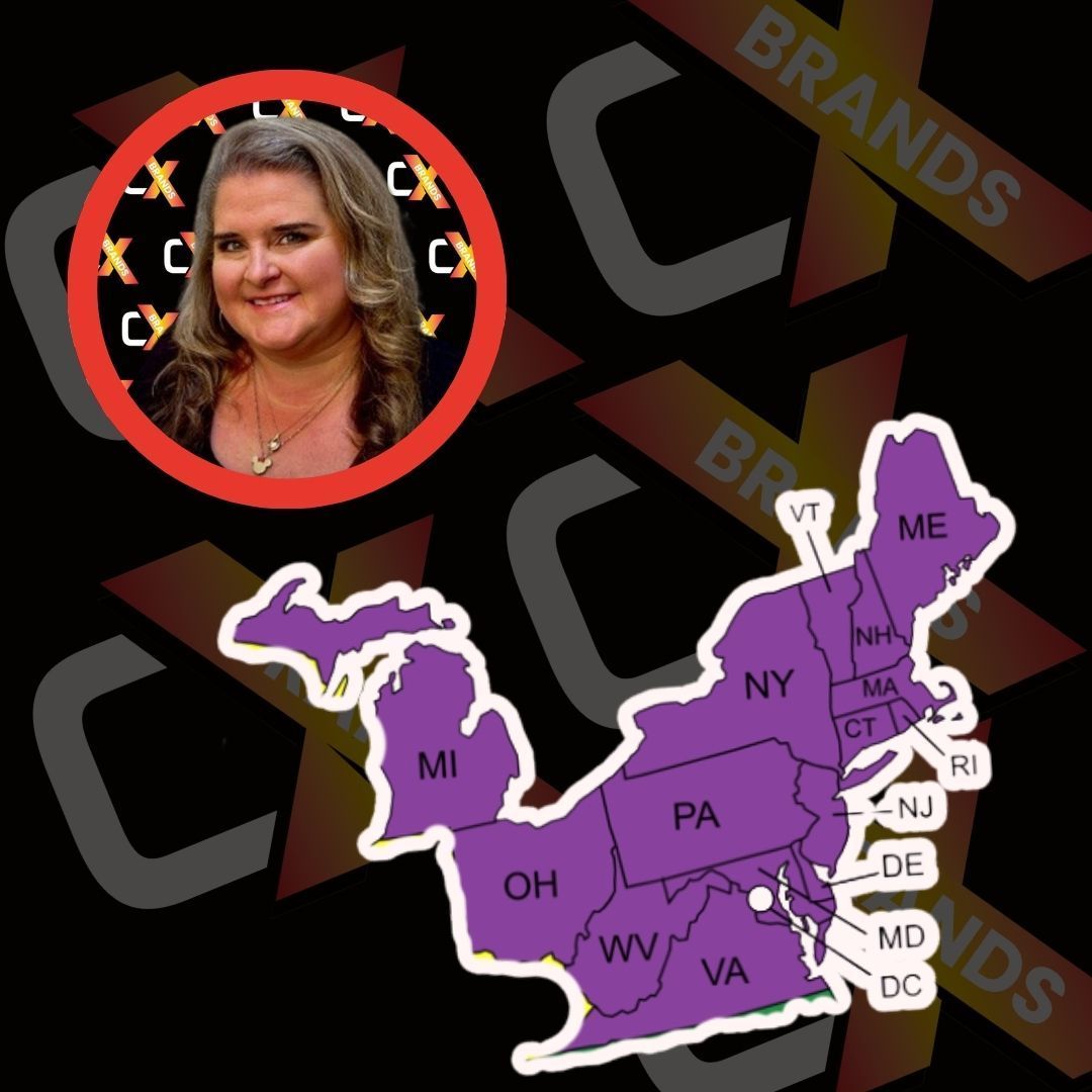 A man with a beard is smiling in front of a sign that says the expo