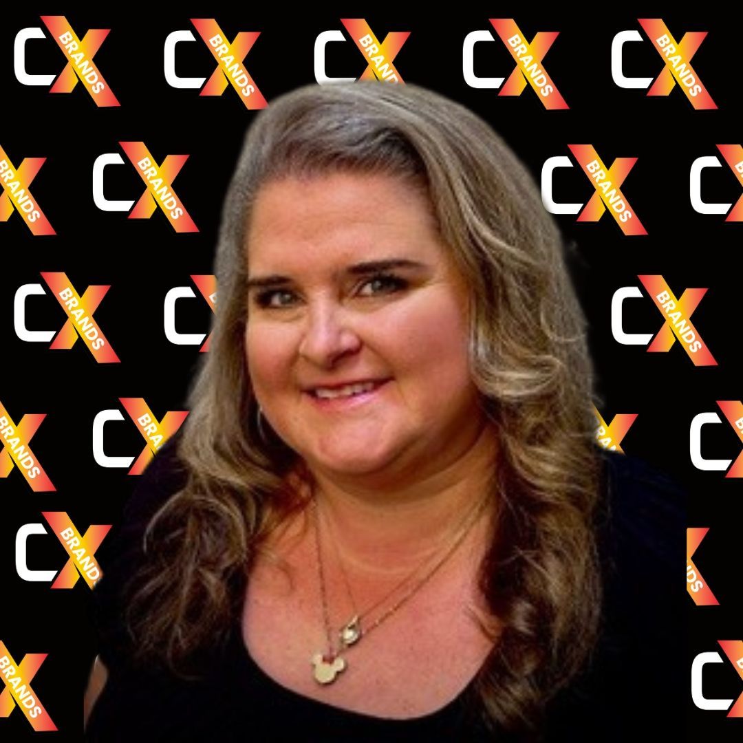 A man with a beard is smiling in front of a sign that says the expo