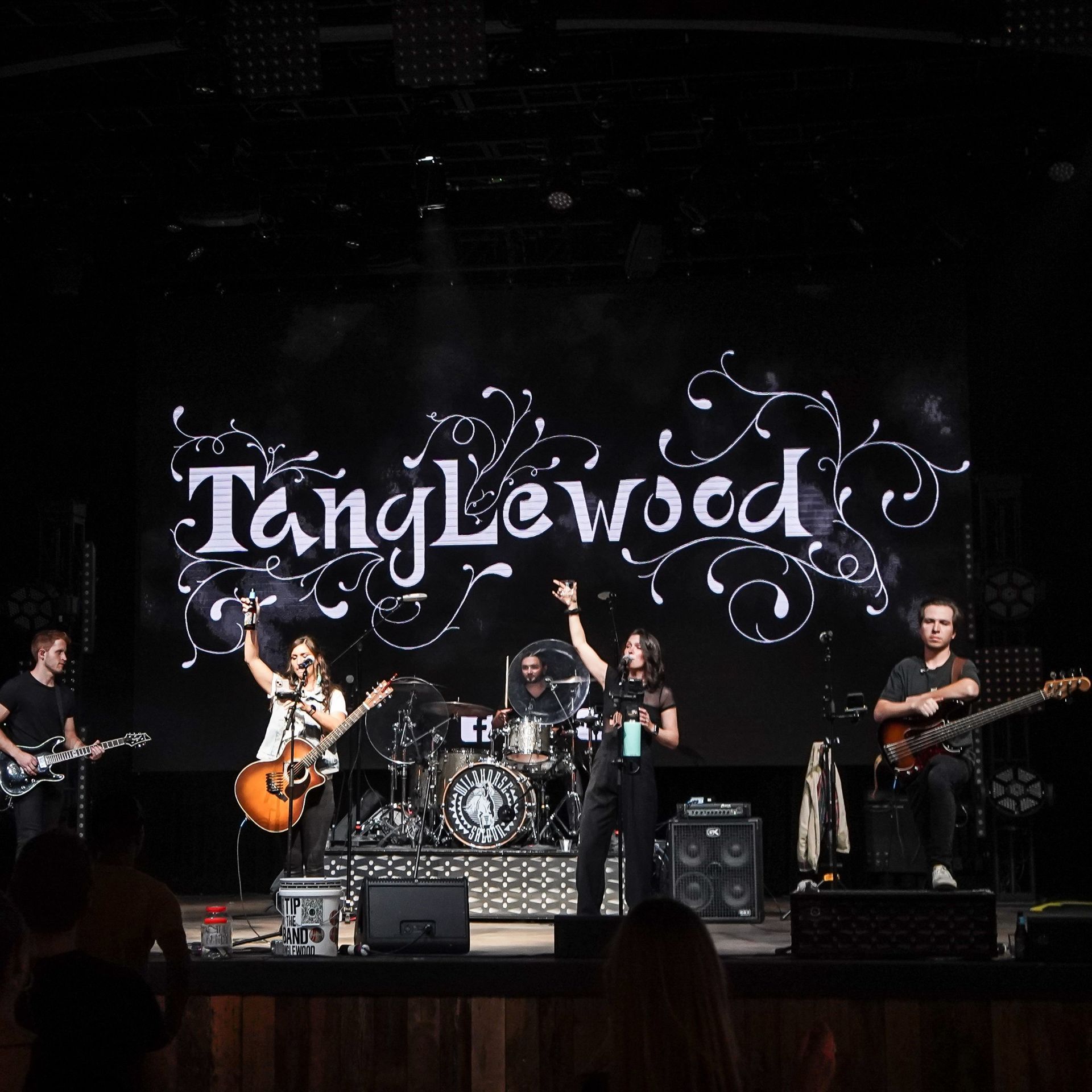 A group of people on a stage with a sign that says tanglewood